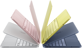MacBook Neo laptops in silver, blush, citrus, and indigo colors, slightly open and arranged in an arch formation