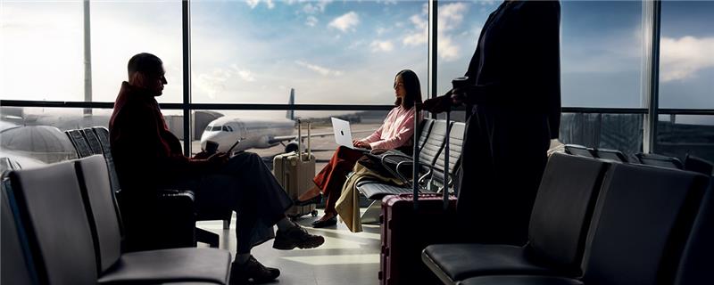 A person enrolling a phone using a MacBook, demonstrating device management.